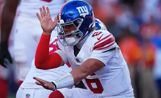 New York Giants quarterback Jaxson Dart (6) celebrates after tight end Theo Johnson scored against the Denver Broncos during the second half of an NFL football game in Denver, Sunday, Oct. 19, 2025. (AP Photo/Jack Dempsey)