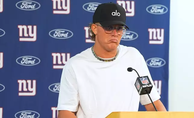 New York Giants quarterback Jaxson Dart responds to questions after an NFL football game against the Denver Broncos, Sunday, Oct. 19, 2025, in Denver. (AP Photo/David Zalubowski)
