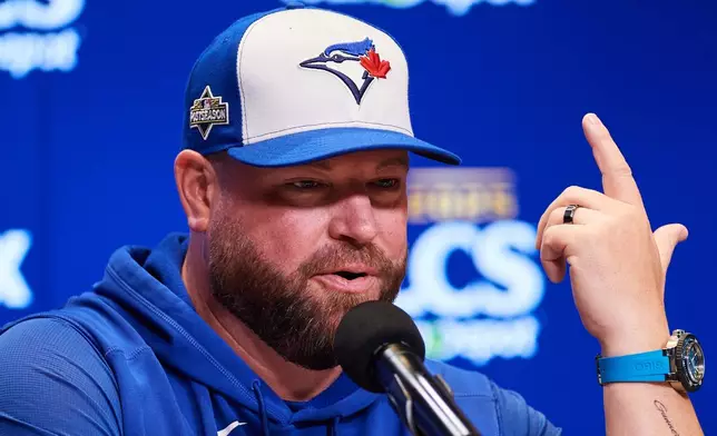 Toronto Blue Jays manager John Schneider speaks with the media ahead of Game 1 of baseball's American League Championship Series against the Seattle Mariners in Toronto, Saturday, Oct. 11, 2025. (Sammy Kogan/The Canadian Press via AP)