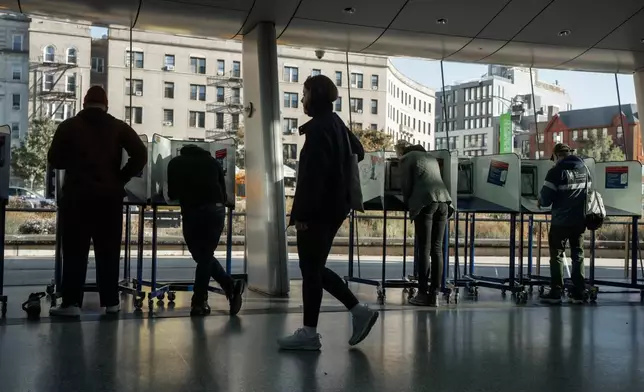 People cast their ballots during early voting on Saturday, Oct. 25, 2025, in New York. (AP Photo/Olga Fedorova)