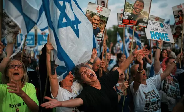 People gather at a plaza known as the hostages square in Tel Aviv, Israel, Monday, Oct. 13, 2025 prior to the release of Israeli hostages held in Gaza. (AP Photo/Emilio Morenatti)