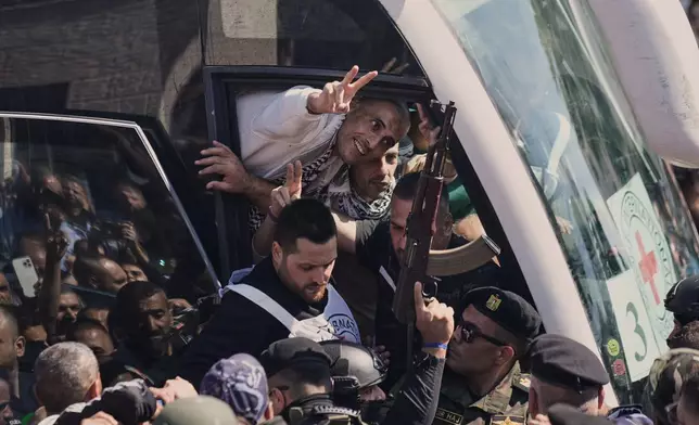 A Palestinian prisoner makes the victory sign after being released from an Israeli prison as part of a ceasefire deal between Israel and Hamas, upon his arrival in the West Bank city of Ramallah, Monday, Oct. 13, 2025. (AP Photo/Majdi Mohammed)