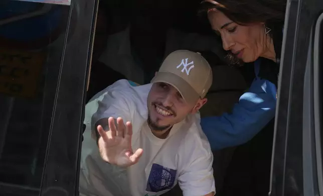 Freed Israeli hostage Eitan Mor gestures from a van as he arrives at Beilinson hospital in Petah Tikva, Israel, after he was released from Hamas captivity in the Gaza Stripl, Monday, Oct. 13, 2025. (AP Photo/Ariel Schalit)
