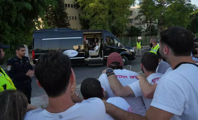 Freed Israeli hostage Evyatar David gestures from a van as he arrives at Beilinson hospital in Petah Tikva, Israel, after he was released from Hamas captivity in the Gaza Stripl, Monday, Oct. 13, 2025. (AP Photo/Francisco Seco)