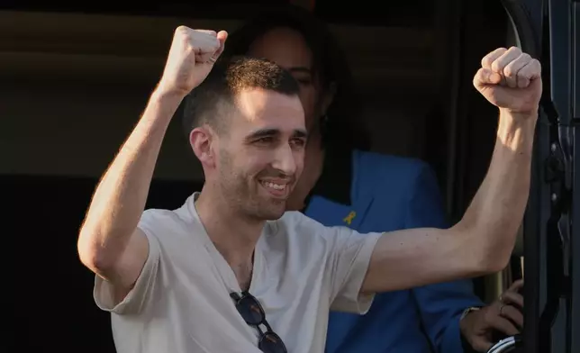 Freed Israeli hostage Avinatan Or gestures from a van as he arrives at Beilinson hospital in Petah Tikva, Israel, after he was released from Hamas captivity in the Gaza Stripl, Monday, Oct. 13, 2025. (AP Photo/Ariel Schalit)