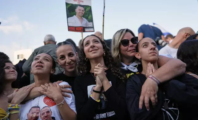 People react in anticipation of the release of Israeli hostages held in Gaza during a gathering at a plaza known as hostages square in Tel Aviv, Israel, Monday, Oct. 13, 2025. (AP Photo/Oded Balilty)