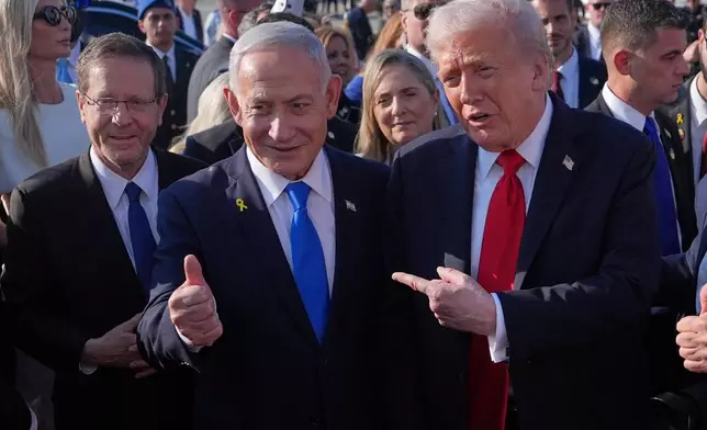 President Donald Trump poses for a photo with Israel's Prime Minister Benjamin Netanyahu before he boards Air Force One at Ben Gurion International Airport, Monday, Oct. 13, 2025, near Tel Aviv, as Israel's President Isaac Herzog watches at left. (AP Photo/Evan Vucci)