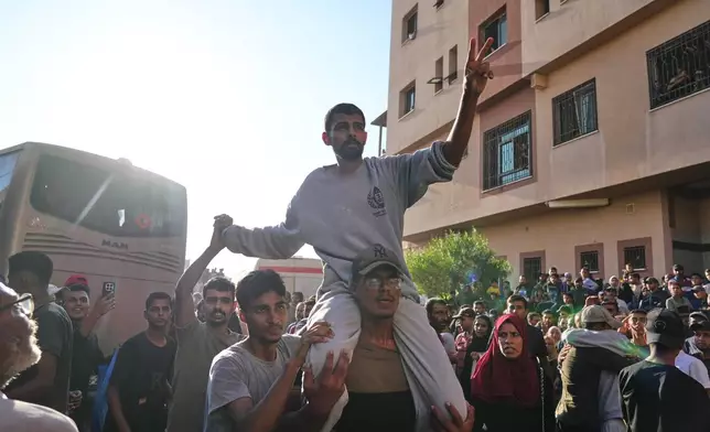 A freed Palestinian prisoner is greeted by a crowd as he arrives in the Gaza Strip after his release from Israeli jails under a ceasefire agreement between Hamas and Israel, in Khan Younis, southern Gaza Strip, Monday, Oct. 13, 2025. (AP Photo/Jehad Alshrafi)