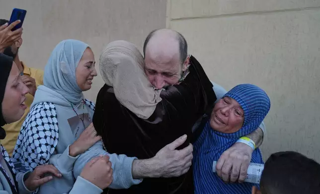 A freed Palestinian prisoner is welcomed by relatives upon arriving in the Gaza Strip after being released from Israeli jails under a ceasefire agreement between Hamas and Israel, in Khan Younis, southern Gaza Strip, Monday, Oct. 13, 2025. (AP Photo/Jehad Alshrafi)