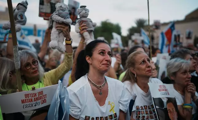 People gather at a plaza known as the hostages square in Tel Aviv, Israel, Monday, Oct. 13, 2025 prior to the release of Israeli hostages held in Gaza. (AP Photo/Emilio Morenatti)