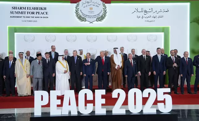 President Donald Trump and other leaders gather for a family photo during a summit to support ending the more than two-year Israel-Hamas war in Gaza after a breakthrough ceasefire deal, Monday, Oct. 13, 2025, in Sharm El Sheikh, Egypt. (AP Photo/Evan Vucci, Pool)