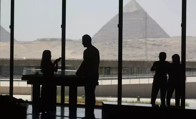 Tourists view the site of the great Pyramids from the rest zone of the Grand Egyptian Museum in Giza, Egypt, Friday, May 23, 2025. (AP Photo/Amr Nabil)