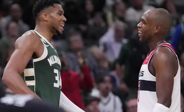 Milwaukee Bucks' Giannis Antetokounmpo and Washington Wizards' Khris Middleton share a laugh during the second half of an NBA basketball game Wednesday, Oct. 22, 2025, in Milwaukee. (AP Photo/Morry Gash)