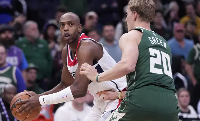 Washington Wizards' Khris Middleton tries to get past Milwaukee Bucks' AJ Green during the first half of an NBA basketball game Wednesday, Oct. 22, 2025, in Milwaukee. (AP Photo/Morry Gash)