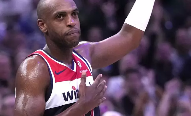 Washington Wizards' Khris Middleton acknowledges the crowd during the first half of an NBA basketball game Wednesday, Oct. 22, 2025, in Milwaukee. (AP Photo/Morry Gash)