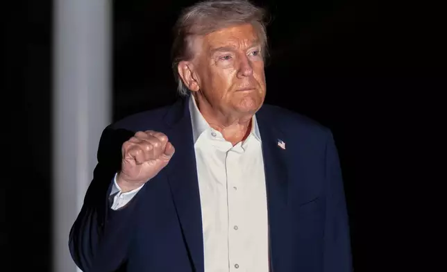 President Donald Trump walks across the South Lawn of the White House, early Tuesday, Oct. 14, 2025, in Washington, after returning from a trip to Israel and Egypt. (AP Photo/Mark Schiefelbein)