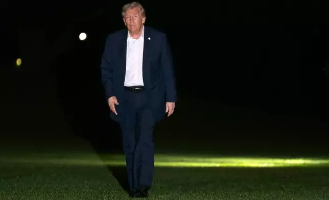 President Donald Trump walks across the South Lawn of the White House, early Tuesday, Oct. 14, 2025, in Washington, after returning from a trip to Israel and Egypt. (AP Photo/Mark Schiefelbein)