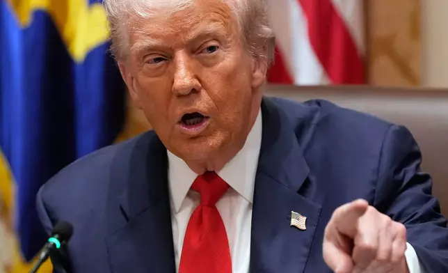 President Donald Trump speaks during a meeting with Argentina's President Javier Milei in the Cabinet Room of the White House, Tuesday, Oct. 14, 2025, in Washington. (AP Photo/Alex Brandon)