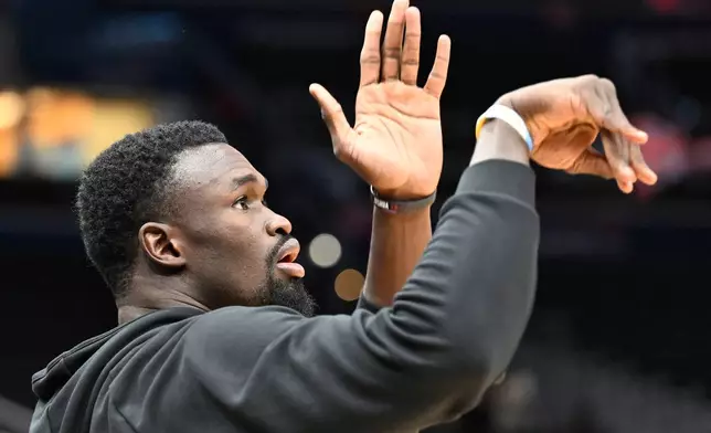 Philadelphia 76ers center Adem Bona warms up before an NBA basketball game against the Washington Wizards, Tuesday, Oct. 28, 2025, in Washington. (AP Photo/John McDonnell)
