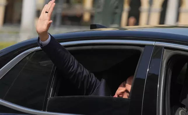 Peru's interim President Jose Jeri waves to the press as he arrives at the government palace in Lima, Peru, Friday, Oct. 10, 2025, the day he was sworn-in after Congress voted to remove Dina Boluarte. (AP Photo/Guadalupe Pardo)