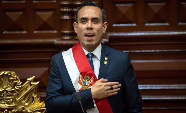 Peru's former president of the Congress Jose Jeri, sings the national anthem after being sworn-in as the interim president in Lima, Peru, Friday, Oct. 10, 2025. (AP Photo/John Reyes)