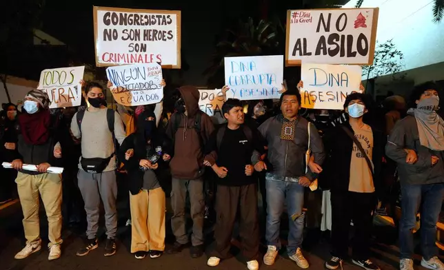 Opponents of Peruvian President Dina Boluarte protest outside of the Ecuadorian Embassy in Lima, Peru, Thursday, Oct. 9, 2025. (AP Photo/Martin Mejia)