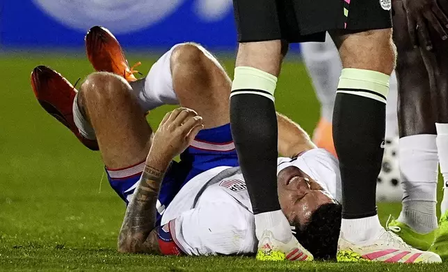 United States forward Chrisitan Pulisic reacts after being injured against Australia in the first half of an international friendly soccer match Tuesday, Oct. 14, 2025, in Commerce City, Colo. (AP Photo/David Zalubowski)
