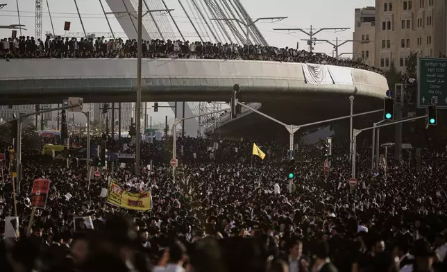 Ultra-Orthodox Jewish men attend a rally against plans to force them to serve in the Israeli military, in Jerusalem, Thursday, Oct. 30, 2025. (AP Photo/Leo Correa)