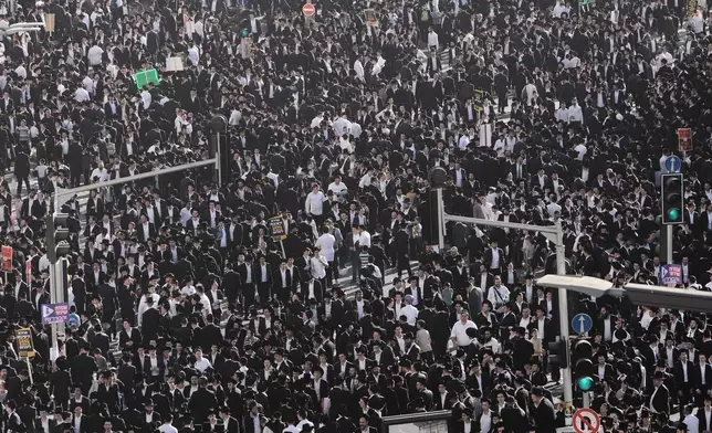 Ultra-Orthodox Jewish men attend a rally against plans to force them to serve in the Israeli military, in Jerusalem, Thursday, Oct. 30, 2025. (AP Photo/Mahmoud Illean)