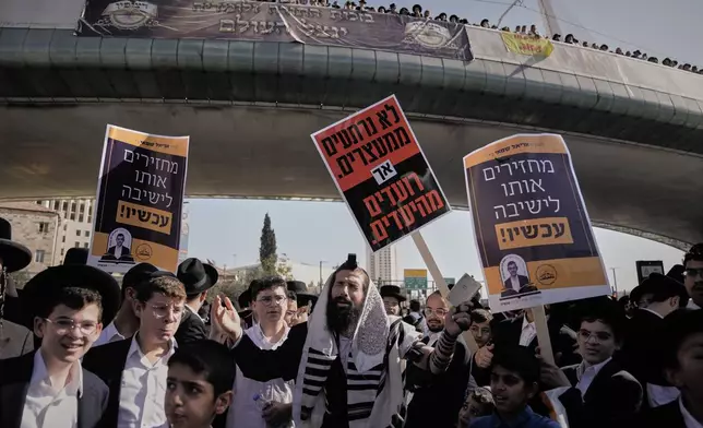 Ultra-Orthodox Jews rally in a massive show against plans to force them to serve in the Israeli military, in Jerusalem, Thursday, Oct. 30, 2025. (AP Photo/Mahmoud Illean)