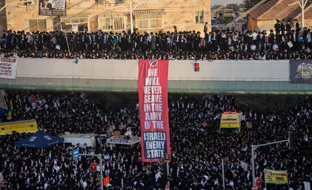 Ultra-Orthodox Jewish men protest against plans to force them to serve in the Israeli military, in Jerusalem, Thursday, Oct. 30, 2025. (AP Photo/Ohad Zwigenberg)