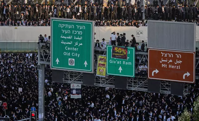 Ultra-Orthodox Jewish men protest against plans to force them to serve in the Israeli military, in Jerusalem, Thursday, Oct. 30, 2025. (AP Photo/Ohad Zwigenberg)