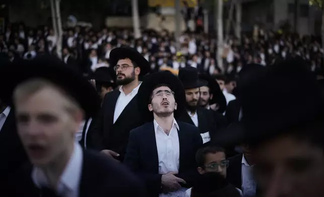 Ultra-Orthodox Jewish men attend a rally against plans to force them to serve in the Israeli military, in Jerusalem, Thursday, Oct. 30, 2025. (AP Photo/Leo Correa)