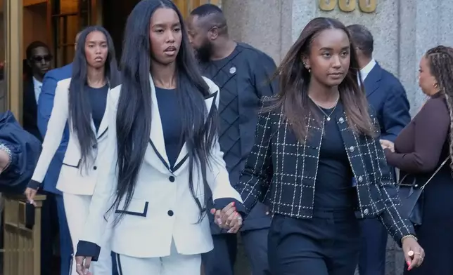 The twin daughters of Sean "Diddy" Combs, Chance Combs, right, and D'Lila Star Combs, leave Federal Court, in New York, Friday, Oct. 3, 2025. (AP Photo/Richard Drew)