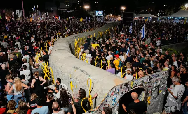 People attend a rally calling for the release of all hostages held by Hamas in the Gaza Strip and urges a ceasefire, in Tel Aviv, Israel, Saturday, Oct. 4, 2025. ahead of the second anniversary of the Israel-Hamas war. (AP Photo/Ohad Zwigenberg)