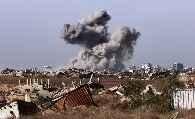 This picture taken during a media tour organised by the Israeli army shows a plume of smoke rising above Gaza City during an Israeli strike, Friday, Oct. 3, 2025. (Jack Guez/Pool Photo via AP)