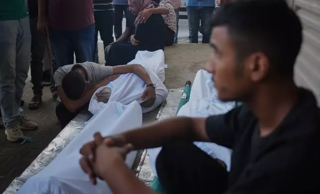 Mourners attend the funeral of Palestinians killed in an Israeli army strike, outside Al-Aqsa Hospital in Deir al-Balah, central Gaza Strip, Saturday, Oct. 4, 2025. (AP Photo/Abdel Kareem Hana)