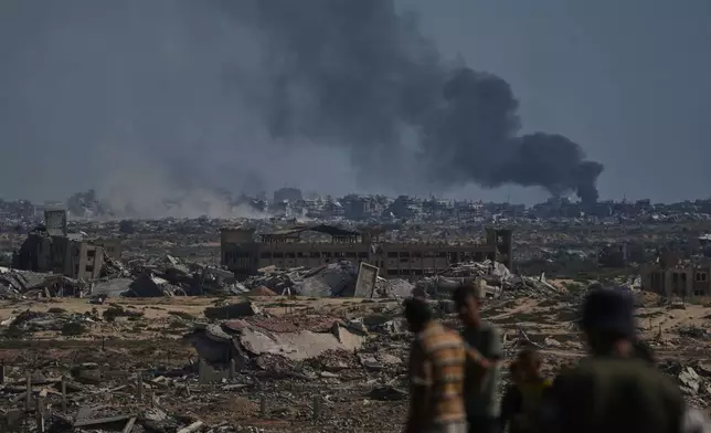 Smoke rises to the sky following an Israeli military strike in Gaza City, as seen from the central Gaza Strip, Thursday, Oct. 2, 2025. (AP Photo/Abdel Kareem Hana)