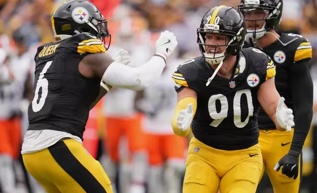 Pittsburgh Steelers outside linebacker T.J. Watt (90) celebrates with linebacker Patrick Queen (6) after a sack of Cleveland Browns quarterback Dillon Gabriel in the first half of an NFL football game in Pittsburgh, Sunday, Oct. 12, 2025. (AP Photo/Gene J. Puskar)