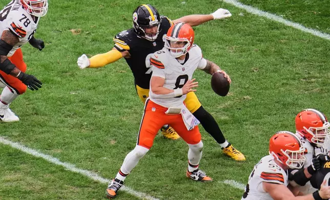 Cleveland Browns quarterback Dillon Gabriel (8) passes under pressure from Pittsburgh Steelers outside linebacker T.J. Watt (90) in the second half of an NFL football game in Pittsburgh, Sunday, Oct. 12, 2025. (AP Photo/Gene J. Puskar)