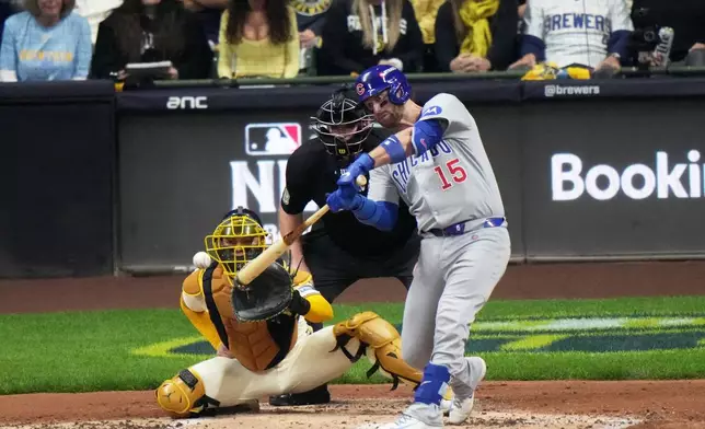 Chicago Cubs' Carson Kelly hits a single during the second inning of Game 5 of baseball's National League Division Series against the Milwaukee Brewers Saturday, Oct. 11, 2025, in Milwaukee. (AP Photo/Morry Gash)