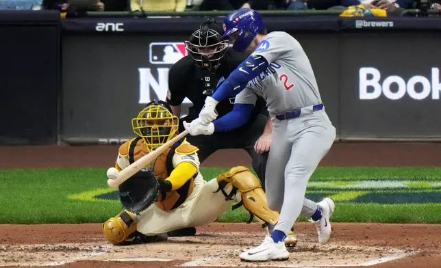 Chicago Cubs' Nico Hoerner hits a single during the third inning of Game 5 of baseball's National League Division Series against the Milwaukee Brewers Saturday, Oct. 11, 2025, in Milwaukee. (AP Photo/Morry Gash)