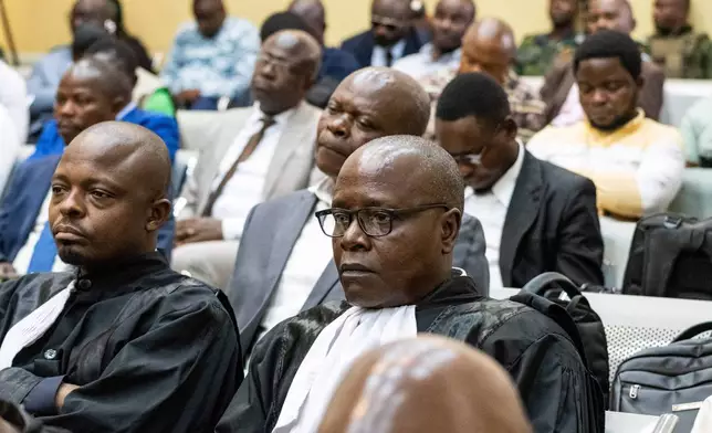 Lawyers and members of the public attend the trial of former Congolese President Joseph Kabila in Kinshasa, Democratic Republic of Congo, Tuesday, Sept. 30, 2025.(AP Photo/ Samy Ntumba Shambuyi)