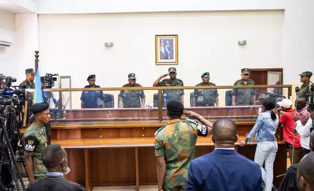 Military officers stand in the dock during the trial of former Congolese President Joseph Kabila in Kinshasa, Democratic Republic of Congo, Tuesday, Sept. 30, 2025 (AP Photo/ Samy Ntumba Shambuyi)