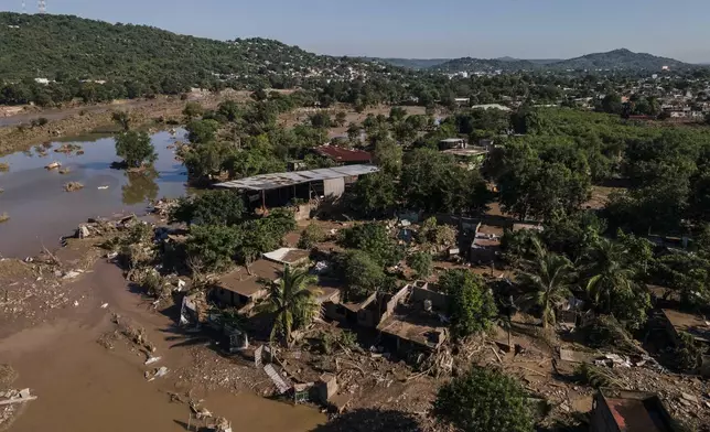 Houses sit damaged after flooding in Poza Rica, Veracruz state, Mexico, Sunday, Oct. 12, 2025. (AP Photo/Felix Marquez)