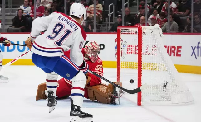 Montreal Canadiens center Oliver Kapanen (91) scores on Detroit Red Wings goalie John Gibson (36) in the first period of an NHL hockey game Thursday, Oct. 9, 2025, in Detroit. (AP Photo/Paul Sancya)