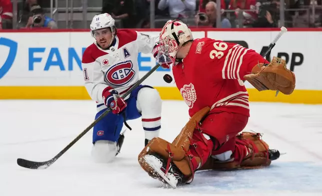 Detroit Red Wings goalie John Gibson (36) stops a Montreal Canadiens right wing Brendan Gallagher (11) shot in the first period of an NHL hockey game Thursday, Oct. 9, 2025, in Detroit. (AP Photo/Paul Sancya)