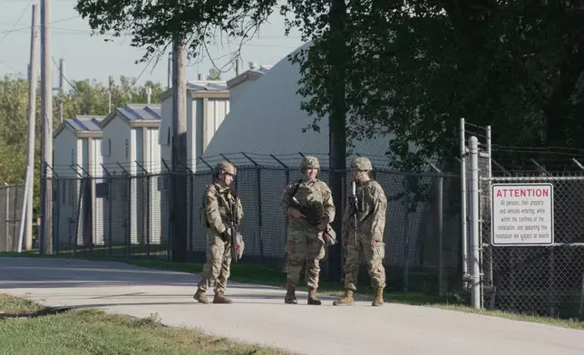 Military personnel in uniform, with the Texas National Guard patch on, are seen at the U.S. Army Reserve Center, Wednesday, Oct. 8, 2025, in Elwood, Ill., a suburb of Chicago. (AP Photo/Laura Bargfeld)