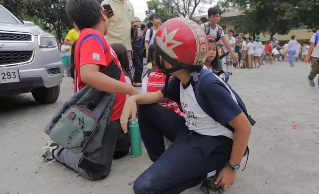 Children evacuate a school after a strong earthquake in Davao City, Philippines on Friday Oct. 10, 2025. (AP Photo/Manman Dejeto)