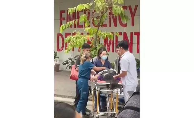 Health workers rush a person injured by an earhtquake to a hospital compound in Davao city, Philippines Friday, Oct. 10, 2025. (Meggy Macion Santos via AP)